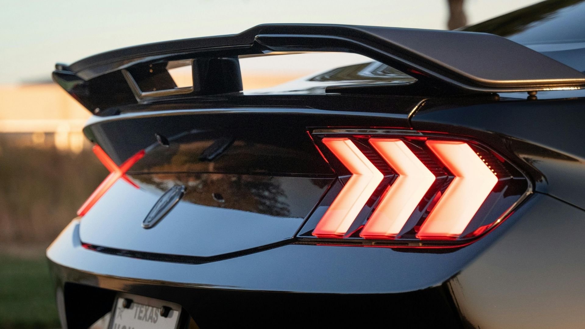 Modern sports car rear taillight with distinctive red chevron-shaped design